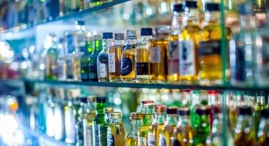 Butelki z alkoholem na szklanych półkach